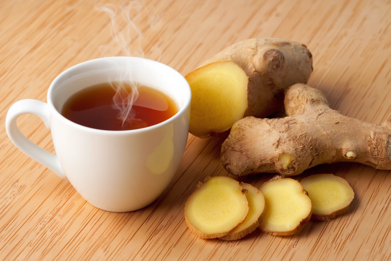 น้ำขิงร้อนและขิงสดบนพื้นไม้